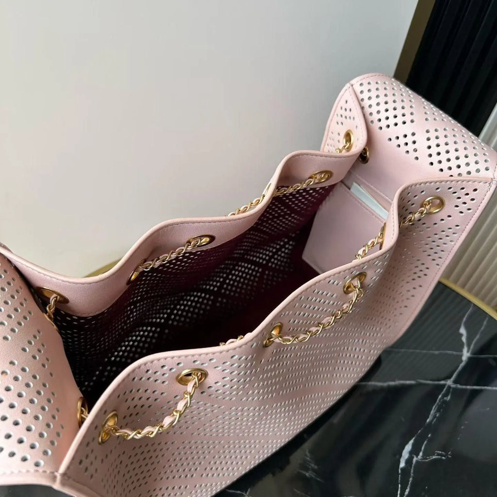 Light Pink Perforated Drawstring Bucket Bag, Interwoven Gold Chain Strap Hollow Grid Cutout Leather Crossbody Purse.