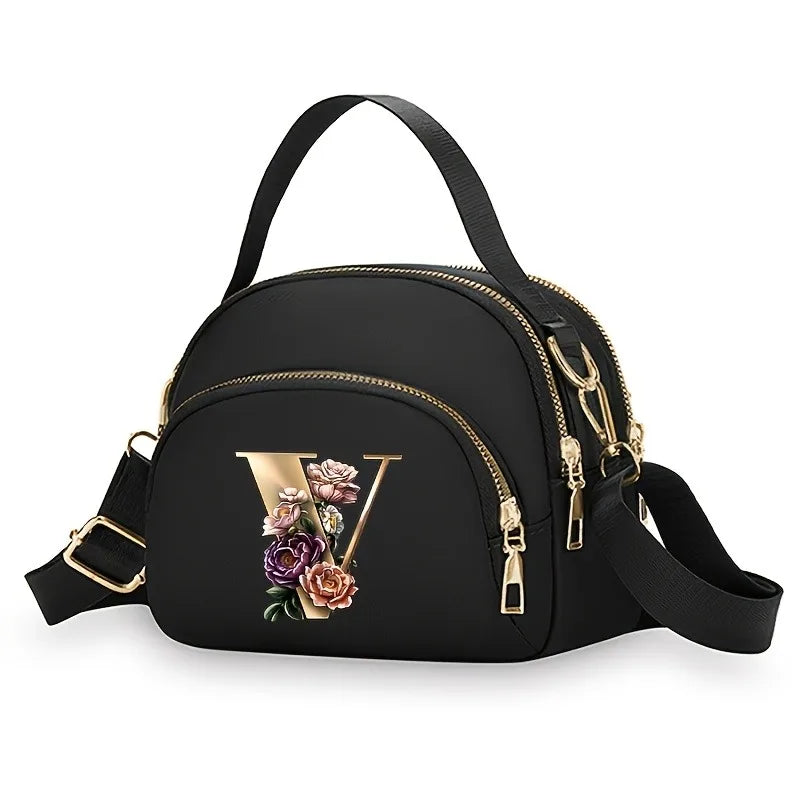 A fashionable women's messenger bag featuring a beautiful floral pattern with 26 letters, multiple compartments, and a large cap