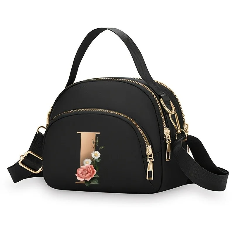 A fashionable women's messenger bag featuring a beautiful floral pattern with 26 letters, multiple compartments, and a large cap