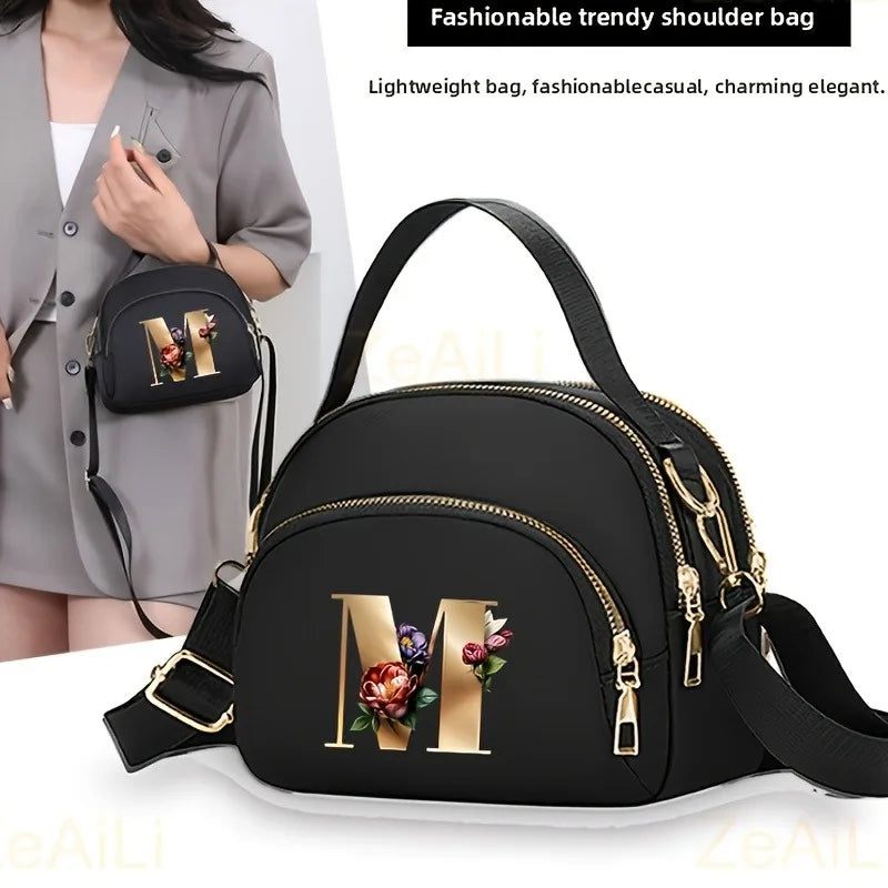 A fashionable women's messenger bag featuring a beautiful floral pattern with 26 letters, multiple compartments, and a large cap
