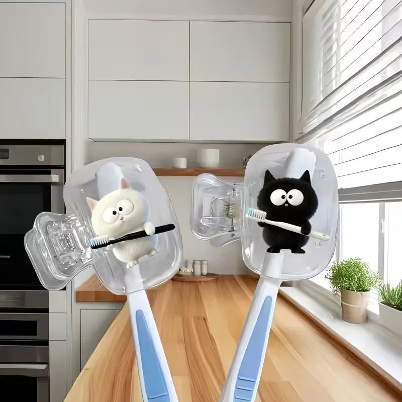 Two white cat toothbrushes and a black cat toothbrush holder, a household toothbrush holder protective cover