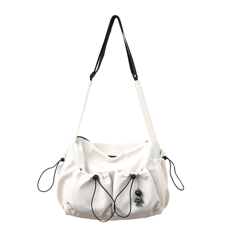 Fashionable Crossbody Bag with Drawstring Accent - Spacious & Secure Zipper Closure - Includes Stylish Bag Charm