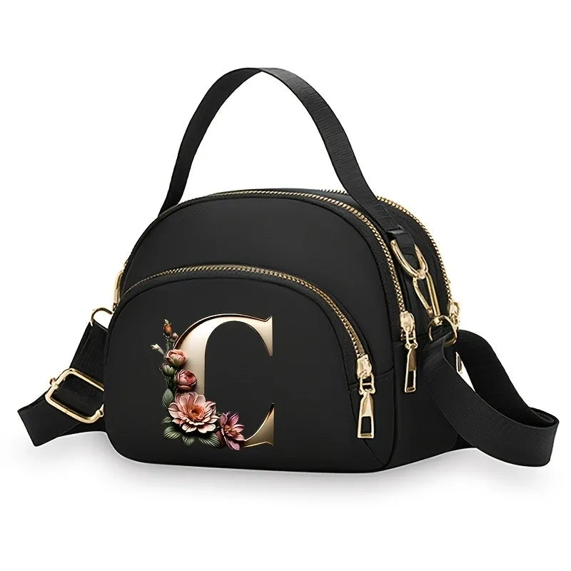 A fashionable women's messenger bag featuring a beautiful floral pattern with 26 letters, multiple compartments, and a large cap