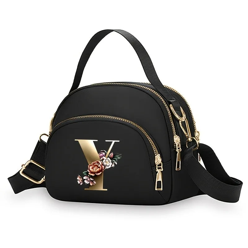 A fashionable women's messenger bag featuring a beautiful floral pattern with 26 letters, multiple compartments, and a large cap