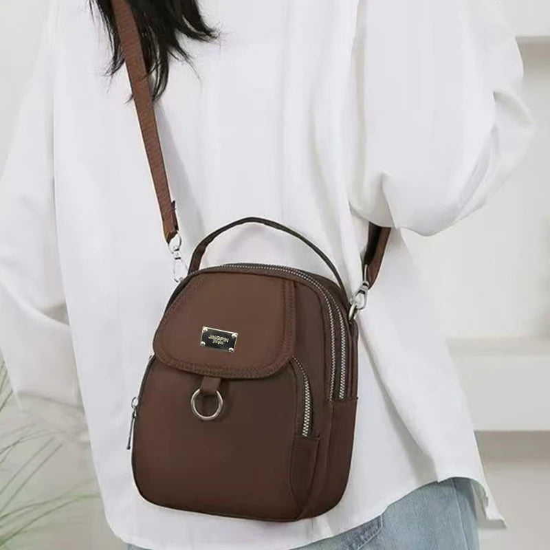 Neutral Style Shoulder Bag for Men and Women, Suitable for Travel and Photography It Is a Cross-Body Bag Made of Oxford Fabric.