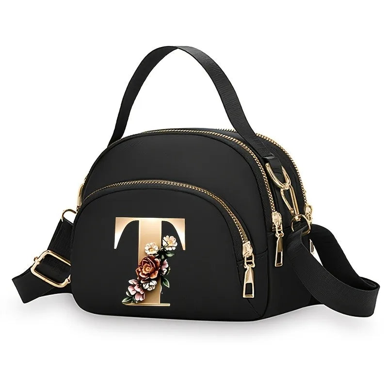 A fashionable women's messenger bag featuring a beautiful floral pattern with 26 letters, multiple compartments, and a large cap