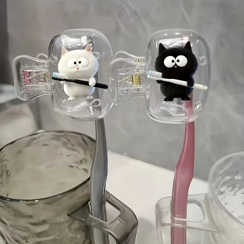 Two white cat toothbrushes and a black cat toothbrush holder, a household toothbrush holder protective cover