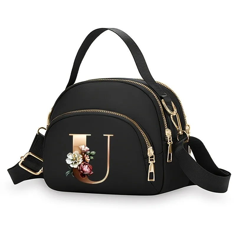 A fashionable women's messenger bag featuring a beautiful floral pattern with 26 letters, multiple compartments, and a large cap