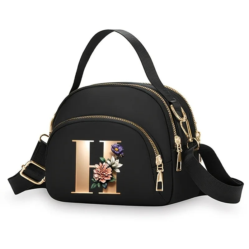 A fashionable women's messenger bag featuring a beautiful floral pattern with 26 letters, multiple compartments, and a large cap