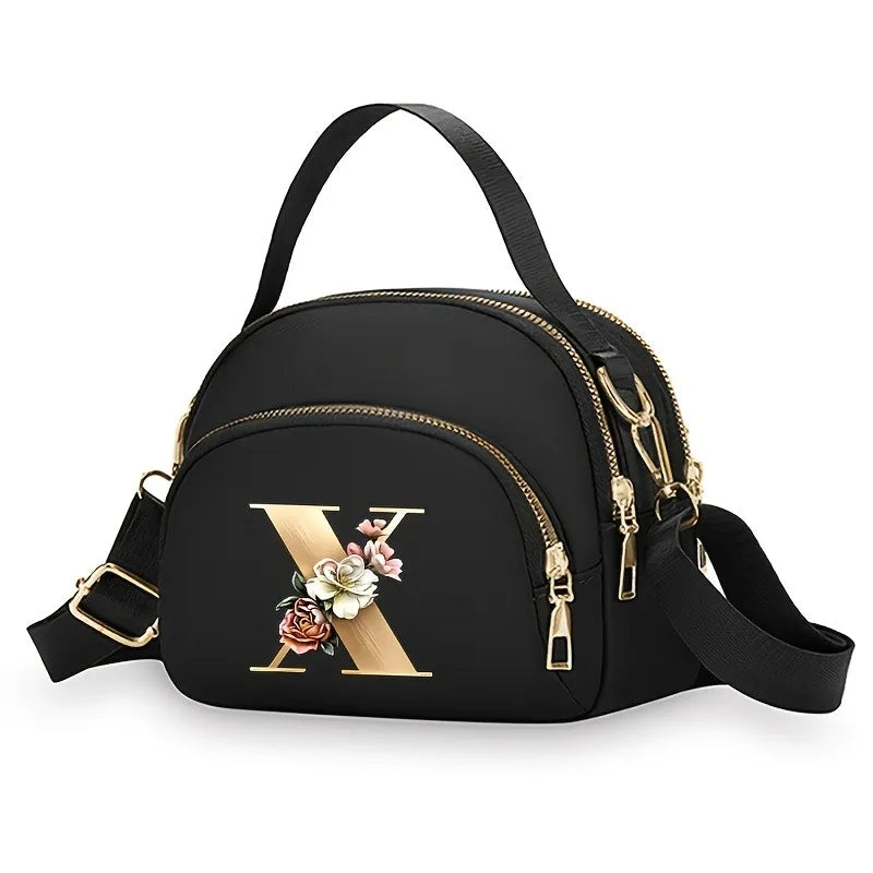 A fashionable women's messenger bag featuring a beautiful floral pattern with 26 letters, multiple compartments, and a large cap