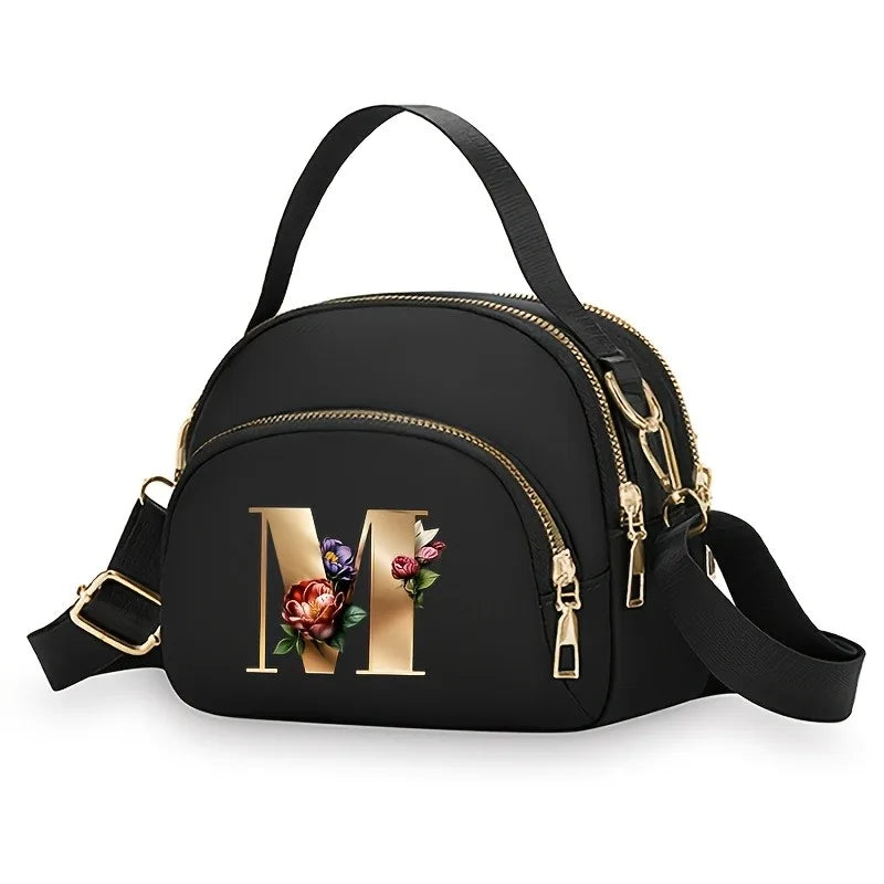 A fashionable women's messenger bag featuring a beautiful floral pattern with 26 letters, multiple compartments, and a large cap