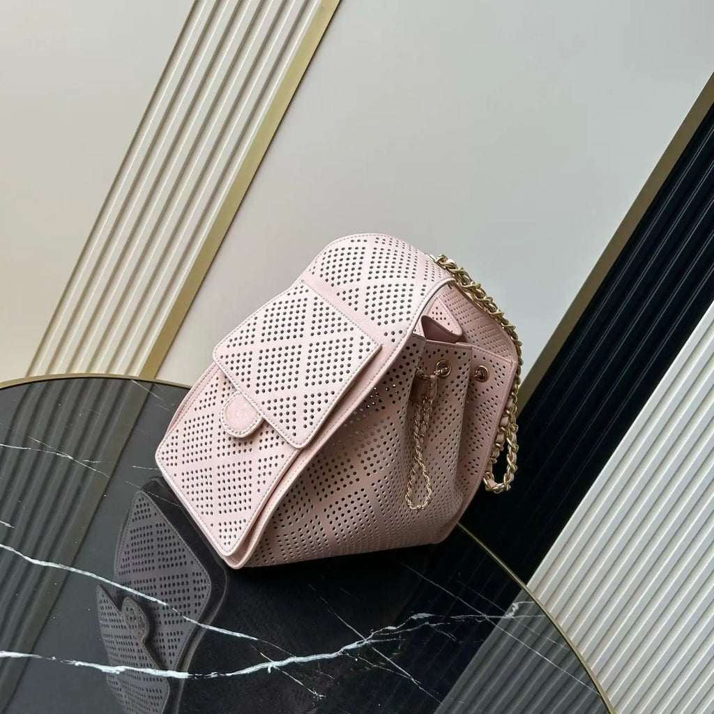 Light Pink Perforated Drawstring Bucket Bag, Interwoven Gold Chain Strap Hollow Grid Cutout Leather Crossbody Purse.