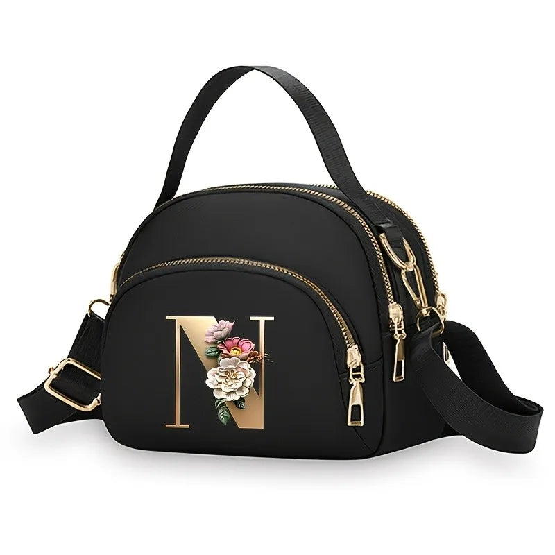 A fashionable women's messenger bag featuring a beautiful floral pattern with 26 letters, multiple compartments, and a large cap