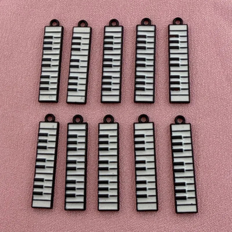 12pcs black and white minimalist alloy drip oil jewelry accessories, piano keyboard keychain, cartoon fashion earrings, hanging
